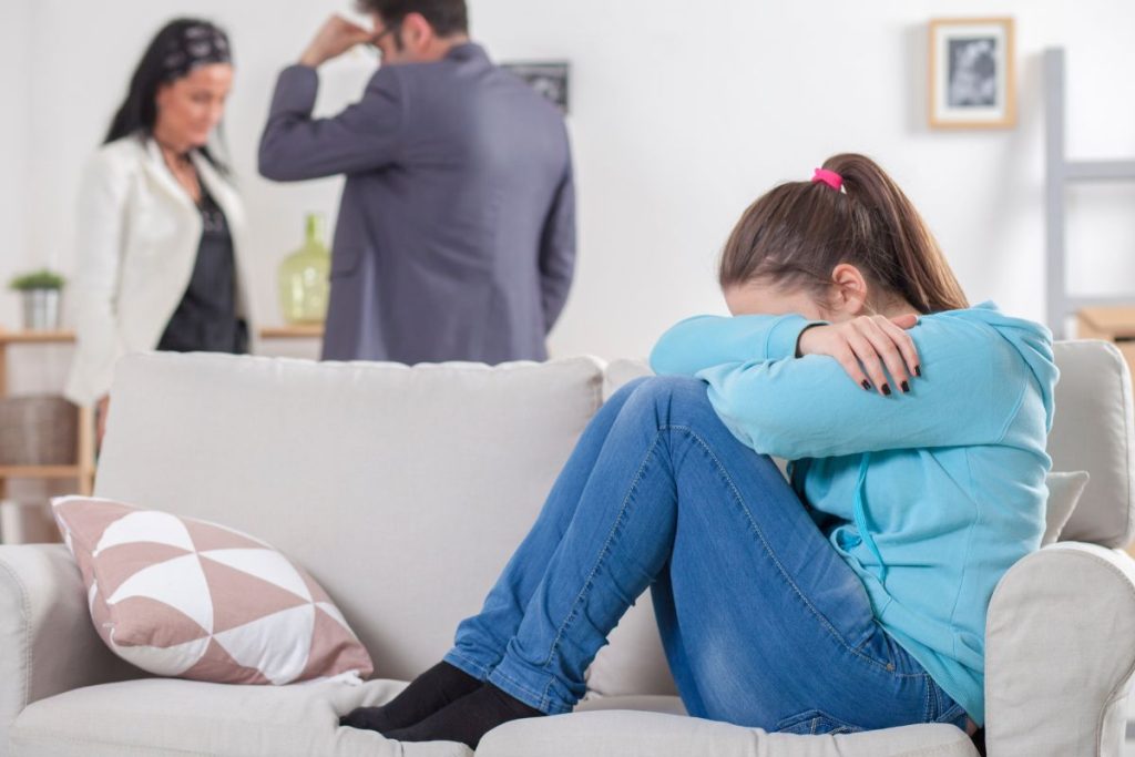 parents arguing in front of teenager